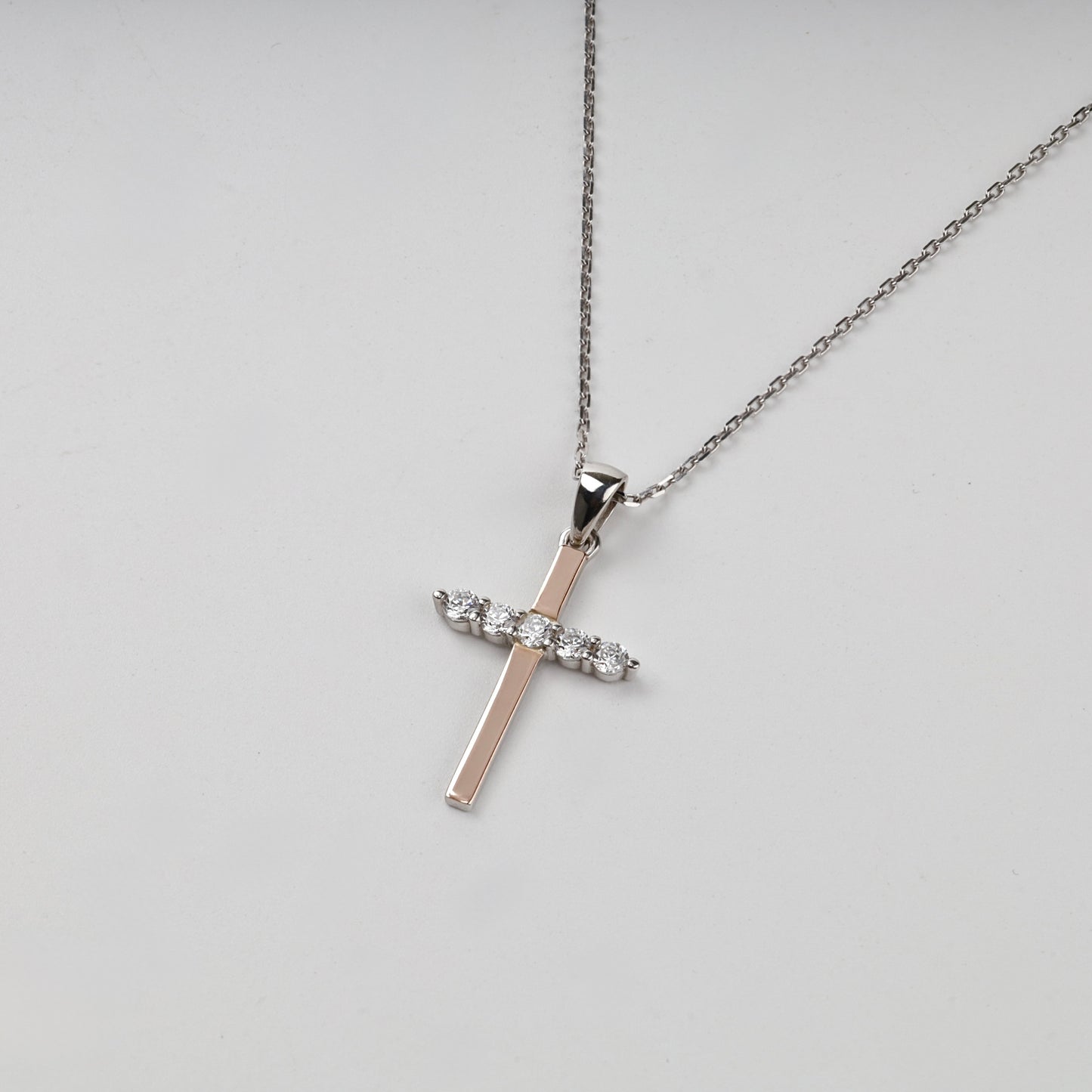 Rhodium-plated Silver 925 and Gold 375 cubic zirconia cross pendant — styled on chain — Kabluchka