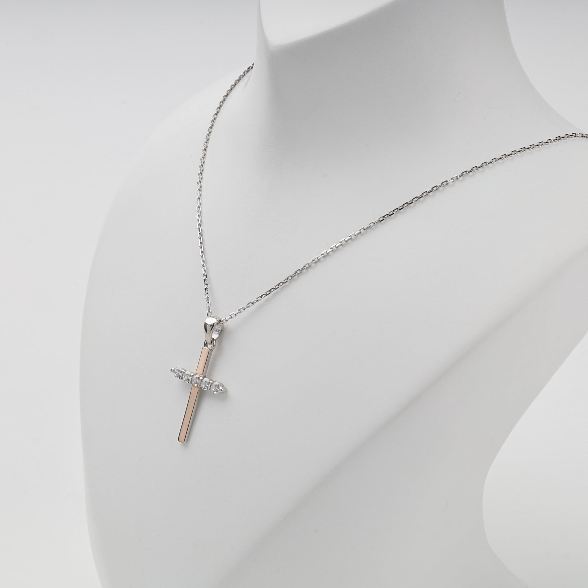 Rhodium-plated Silver 925 and Gold 375 cubic zirconia cross pendant — angled view — Kabluchka