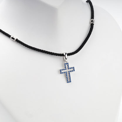 Rhodium-plated silver 925 cross pendant with blue cubic zirconia, back view