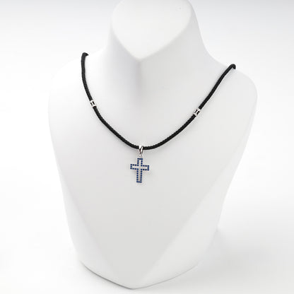 Rhodium-plated silver 925 cross pendant with blue cubic zirconia, side view