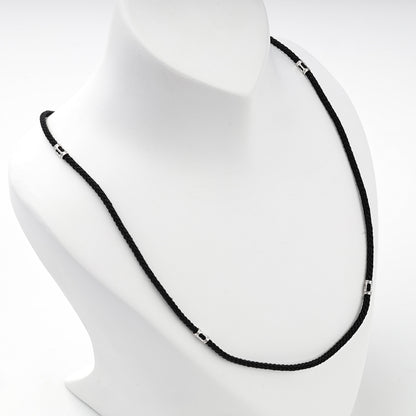 Black braided cord necklace with silver 925 spacer beads, detail view