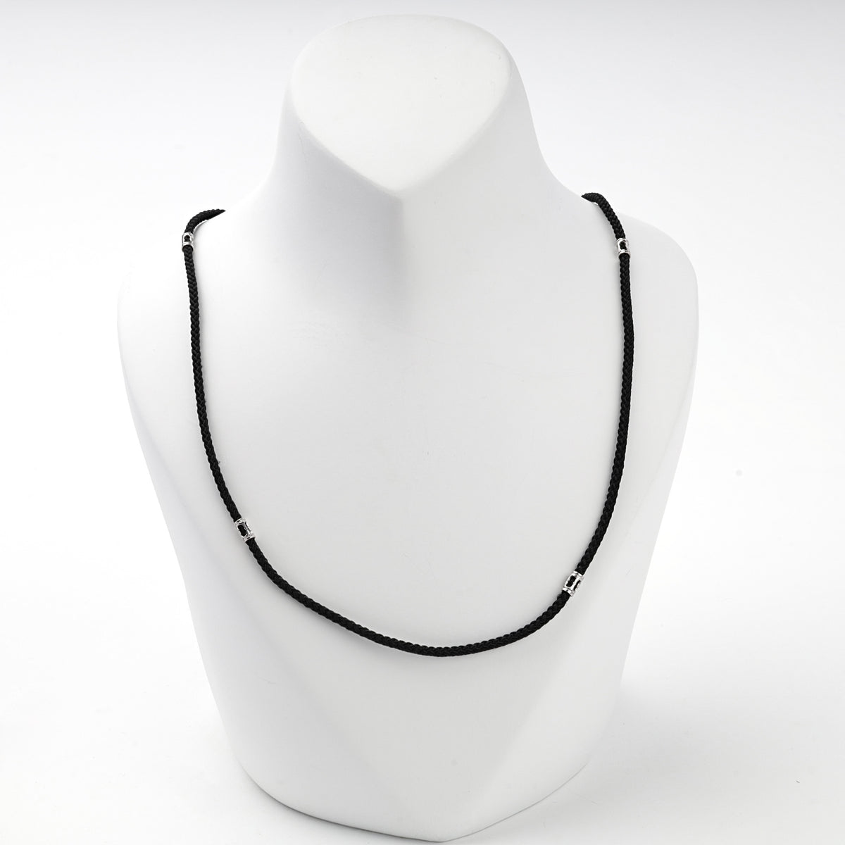 Black braided cord necklace with silver 925 spacer beads, side view
