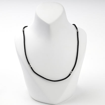 Black braided cord necklace with silver 925 spacer beads, side view
