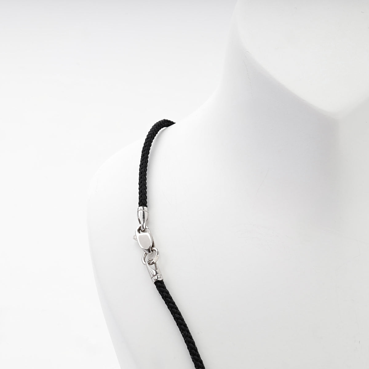 Black braided cord necklace with silver 925 spacer beads, angled view