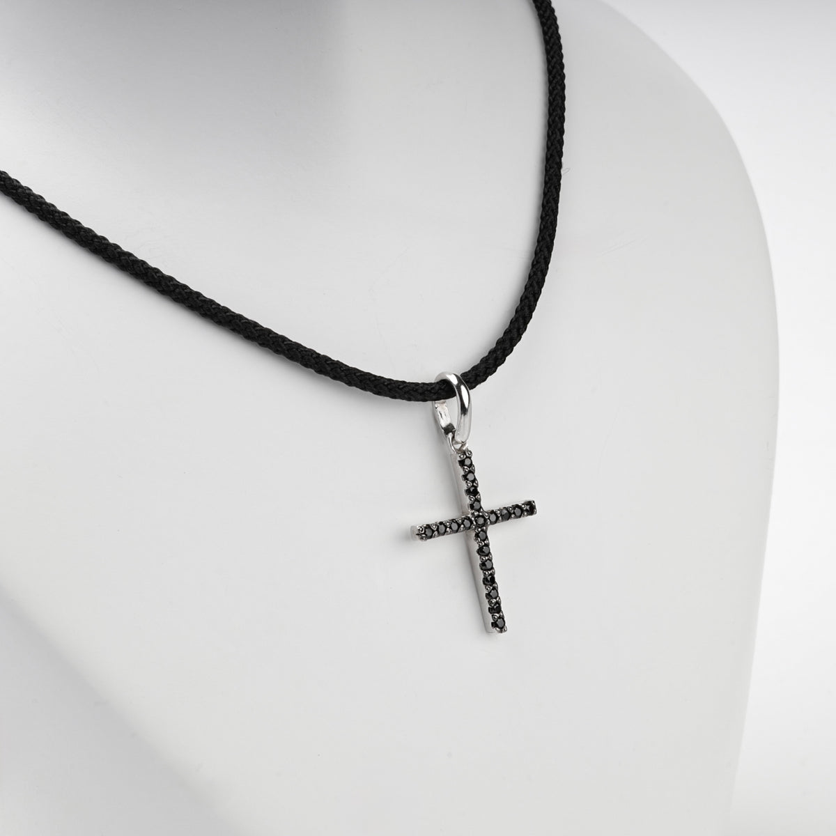 Silver 925 cross pendant with black cubic zirconia, angled view