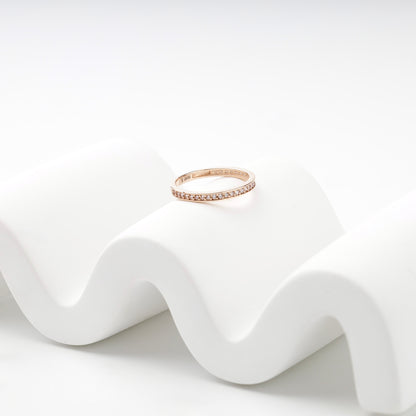 Slim rose gold cubic zirconia band ring on a white display — Kabluchka