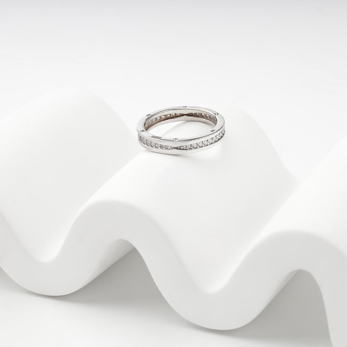 Polished white gold ring with continuous cubic zirconia row