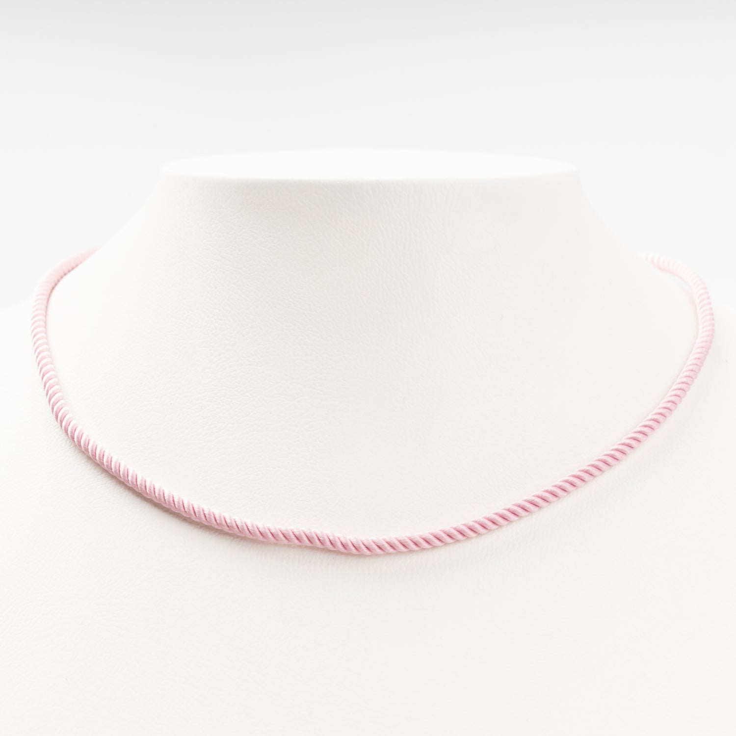 Sophisticated product - a pastel pink twisted silk cord necklace displayed on a white bust, 14K (585) Rose Gold lobster clasp and 585 hallmark.