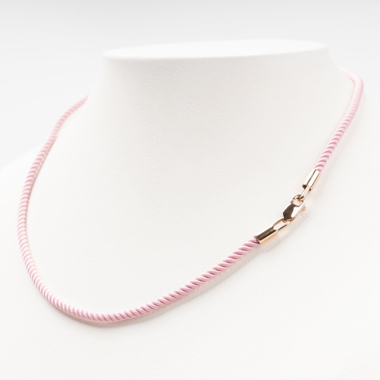 Sophisticated product - a pastel pink twisted silk cord necklace displayed on a white bust, 14K (585) Rose Gold lobster clasp and 585 hallmark.