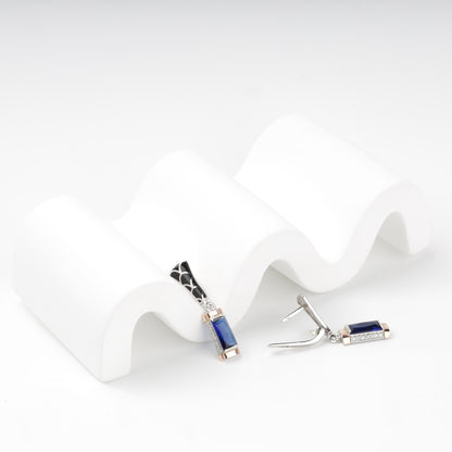 Side view of blue alpinite earrings with gold accents