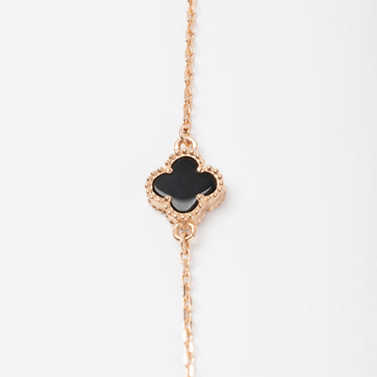 An exquisite 14K (585) Rose Gold bracelet featuring a black four-leaf clover centerpiece accented  on a delicate chain with an adjustable clasp.
