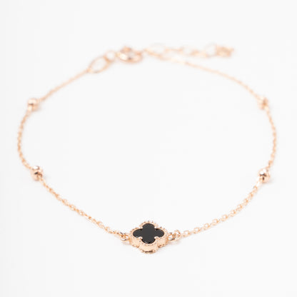 An exquisite 14K (585) Rose Gold bracelet featuring a black four-leaf clover centerpiece accented with four textured, cut-faced gold beads on a delicate chain with an adjustable clasp.