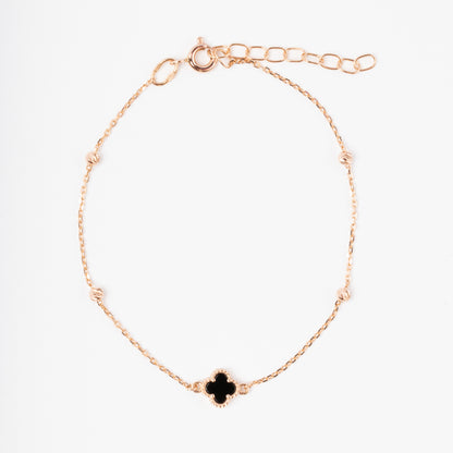 An exquisite 14K (585) Rose Gold bracelet featuring a black four-leaf clover centerpiece accented with four textured, cut-faced gold beads on a delicate chain with an adjustable clasp.