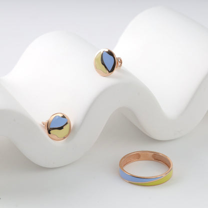 Sophisticated 14K (585) Rose Gold patriotic jewelry set featuring a minimalist wavy enamel ring and matching round stud earrings with vibrant blue and yellow accents, elegantly displayed on a white wavy decorative prop.