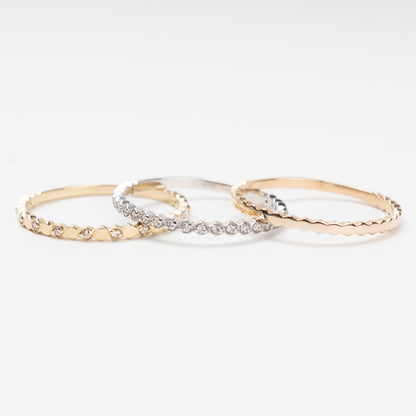 Sophisticated triple stackable ring set in 14K (585) multi-tone gold, featuring a central eternity band of clear zirconias White Gold between two uniquely scalloped Rose and Yellow Gold bands, displayed on a clean white background.