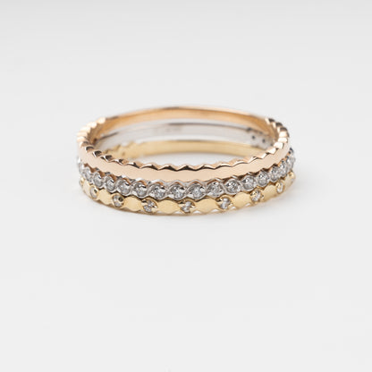 Sophisticated triple stackable ring set in 14K (585) multi-tone gold, featuring a central eternity band of clear zirconias White Gold between two uniquely scalloped Rose and Yellow Gold bands, displayed on a clean white background.