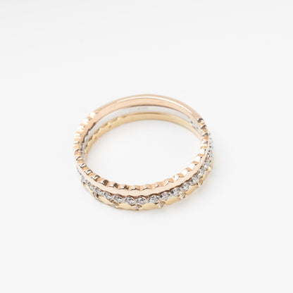 Sophisticated triple stackable ring set in 14K (585) multi-tone gold, featuring a central eternity band of clear zirconias White Gold between two uniquely scalloped Rose and Yellow Gold bands, displayed on a clean white background.
