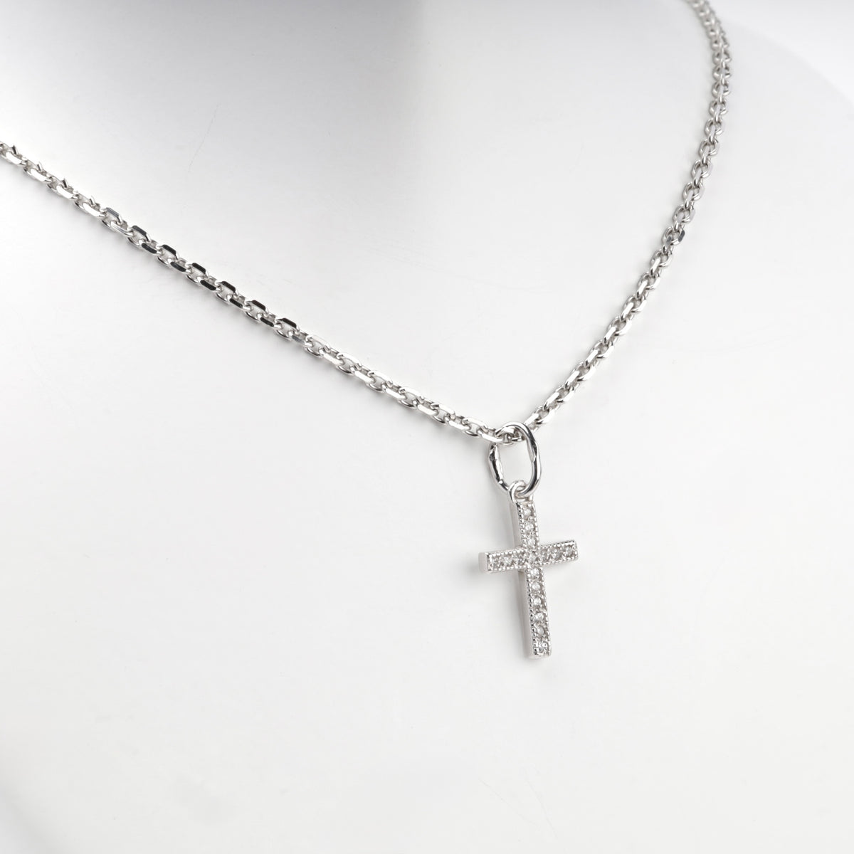Silver 925 cross pendant with clear cubic zirconia, angled view