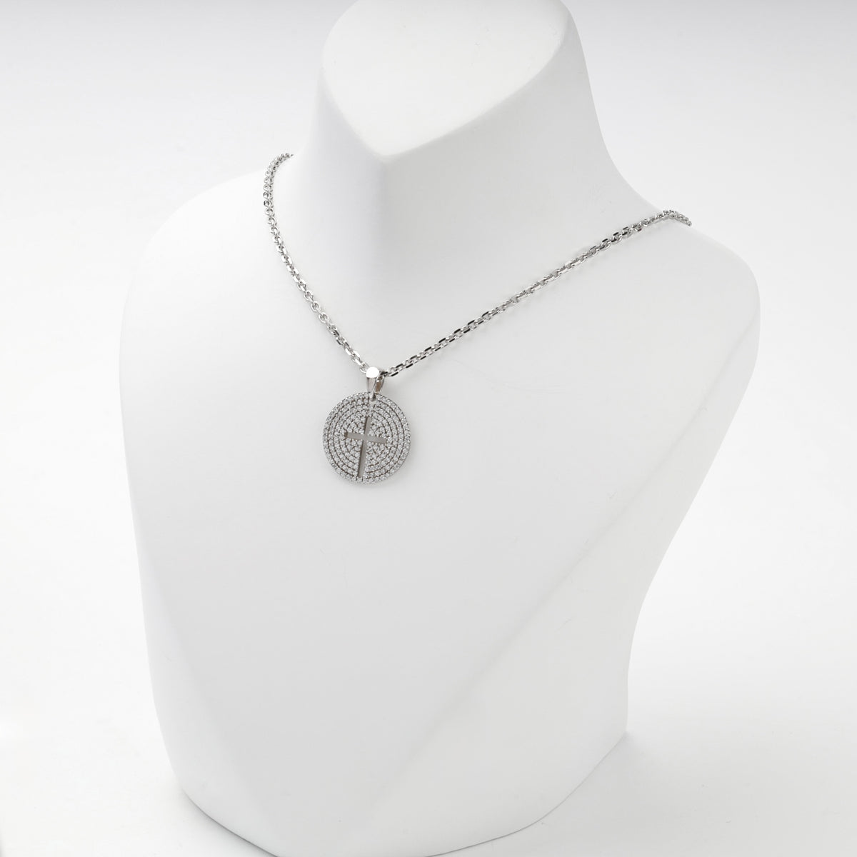 Rhodium-plated silver 925 round cross pendant with clear cubic zirconia, side view