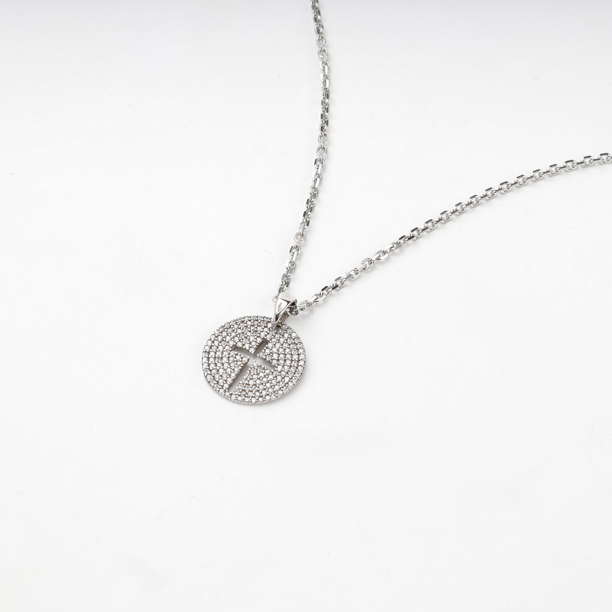 Rhodium-plated silver 925 round cross pendant with clear cubic zirconia, back view