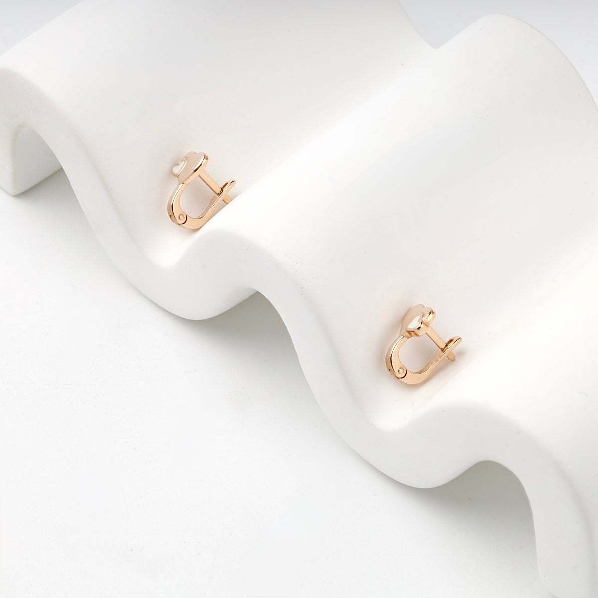 Rose Gold enamel heart kids earrings showing English-lock fastenings