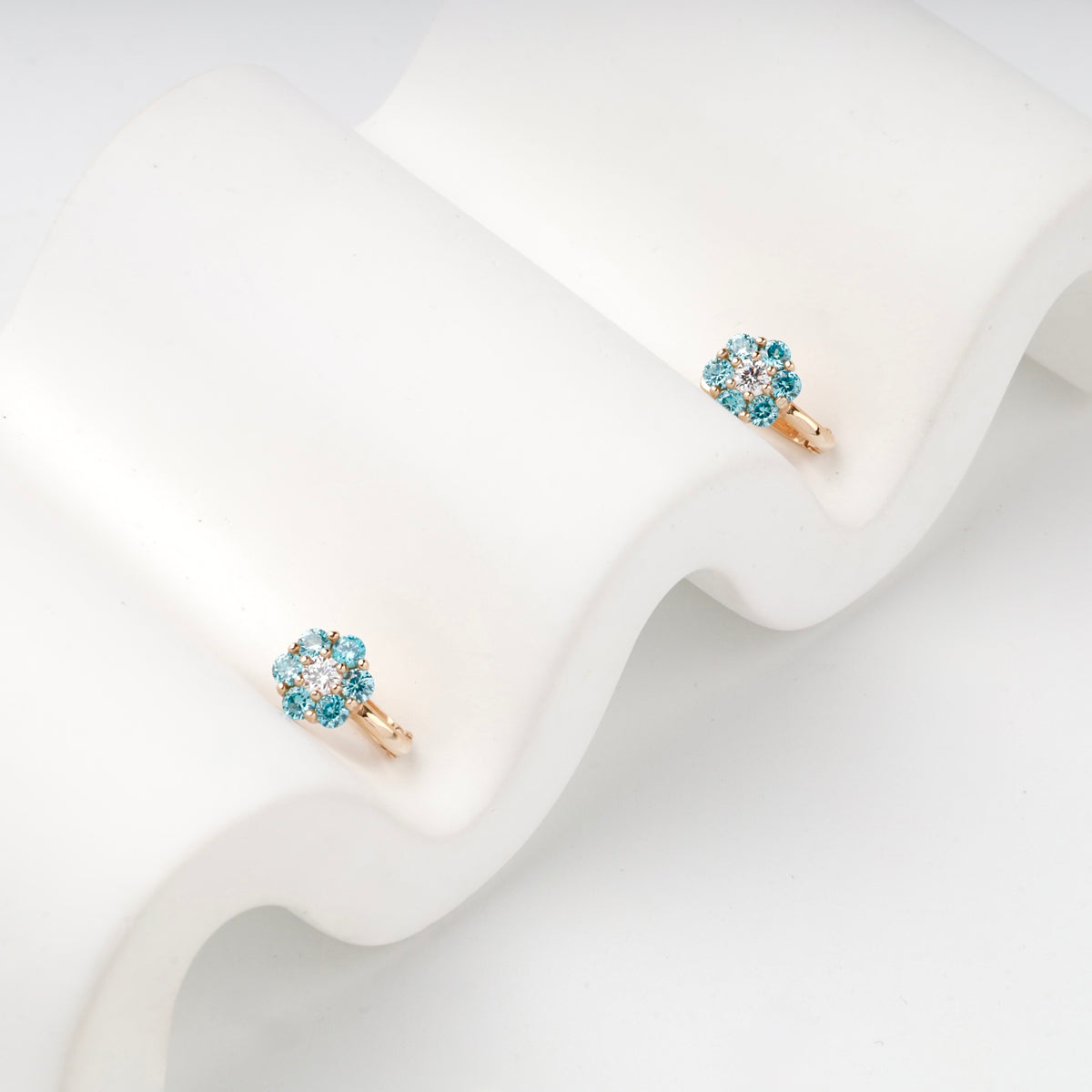Rose Gold 14K (585) Blue and Clear Cubic Zirconia Flower Halo Earrings — angled view — Kabluchka