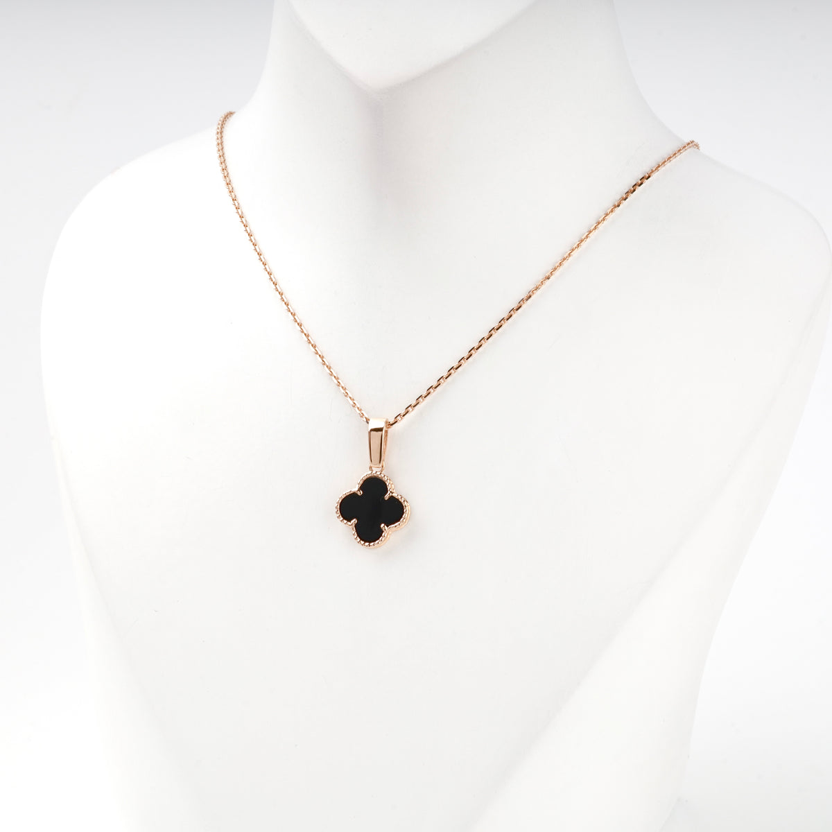 Black onyx clover pendant styled on a chain — Kabluchka
