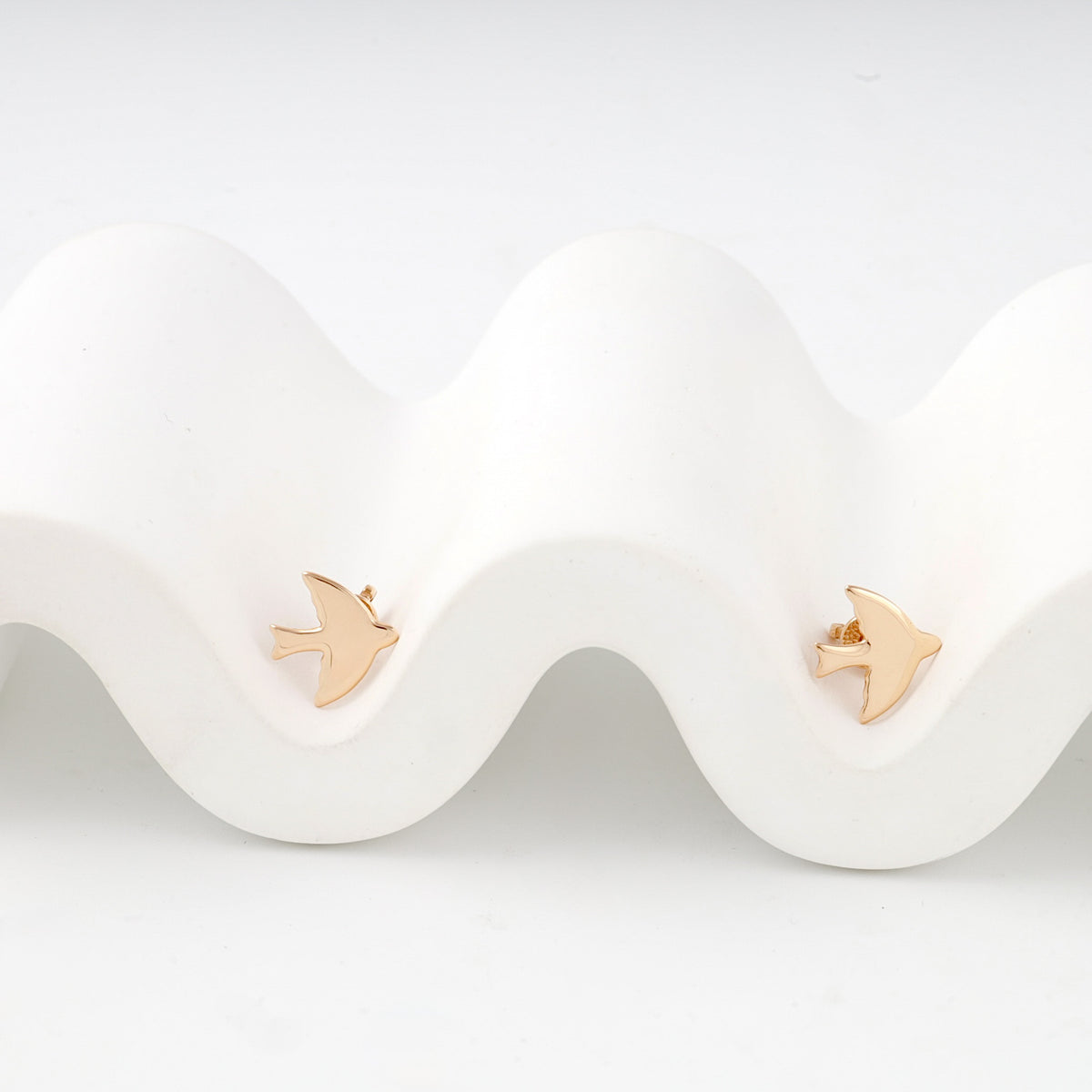 Rose gold polished bird stud earrings — front view — Kabluchka