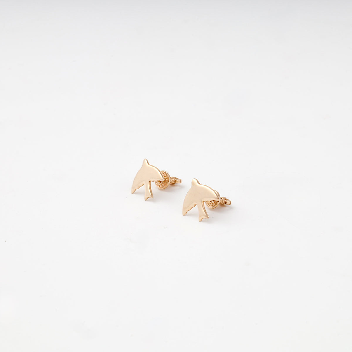 Rose gold flying-bird stud earrings — angled view — Kabluchka