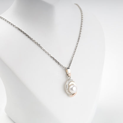 Two-tone pearl pendant shown on chain — front detail — Kabluchka