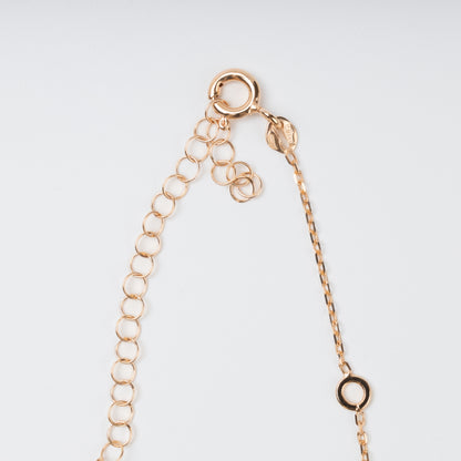 Close-up view of the secure spring-ring clasp, hallmark tag, and adjustable extension chain on a 14K (585) Rose Gold necklace against a plain background.