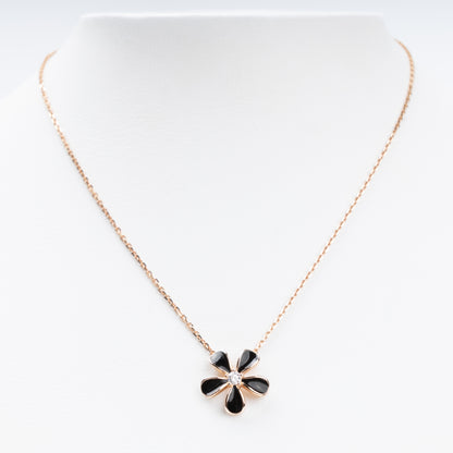 Sophisticated 14K (585) Rose Gold necklace featuring a five-petal flower pendant with black enamel inlays and a brilliant-cut zirconia center, displayed on a white jewelry bust.