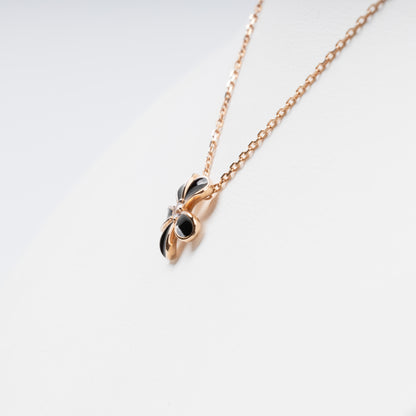 Sophisticated 14K (585) Rose Gold necklace featuring a five-petal flower pendant with black enamel inlays and a brilliant-cut zirconia center, displayed on a white jewelry bust.