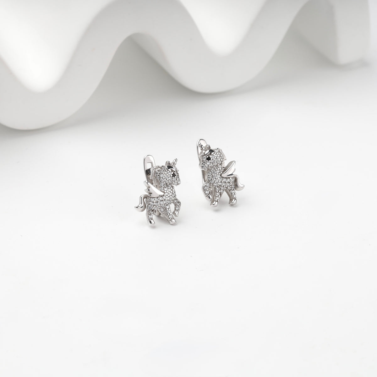 Silver 925 cubic zirconia winged unicorn earrings, front view