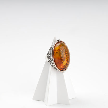 Silver 925 amber ring side view with ornate openwork — Kabluchka