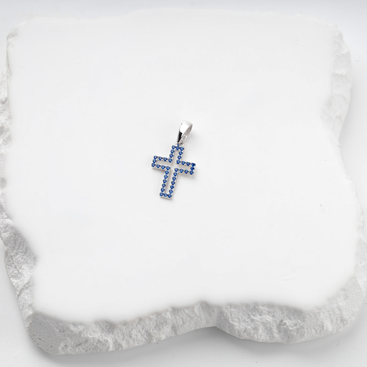 Rhodium-plated silver 925 cross pendant with blue cubic zirconia, front view