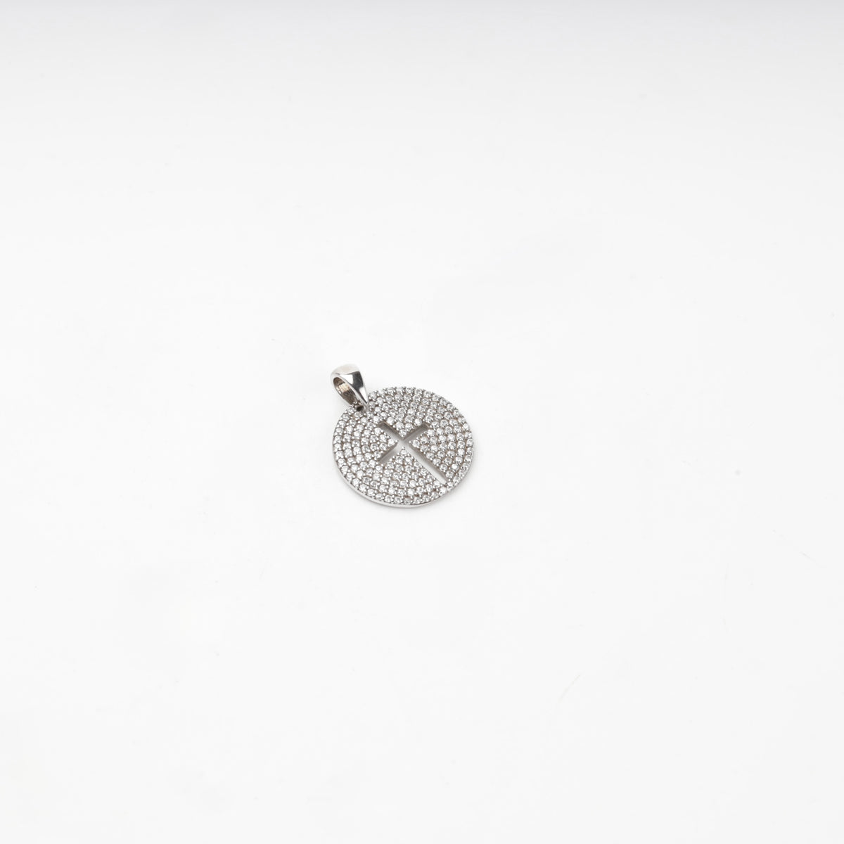 Rhodium-plated silver 925 round cross pendant with clear cubic zirconia, close-up view
