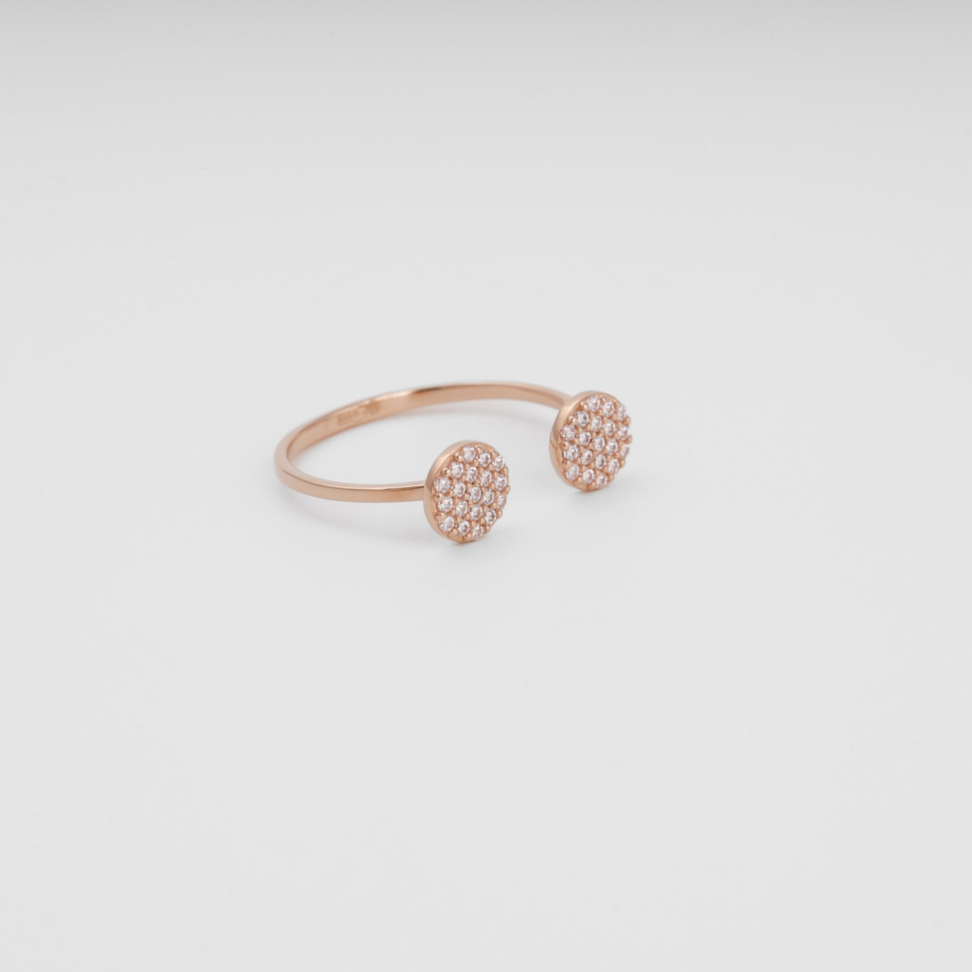 Open cuff ring in 14K rose gold with CZ disc pads three-quarter view - Kabluchka
