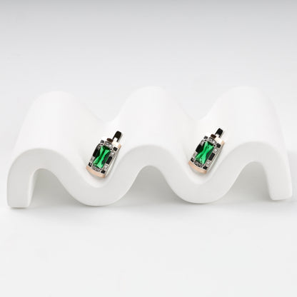 Silver and Gold 375 green alpinite earrings, angled view