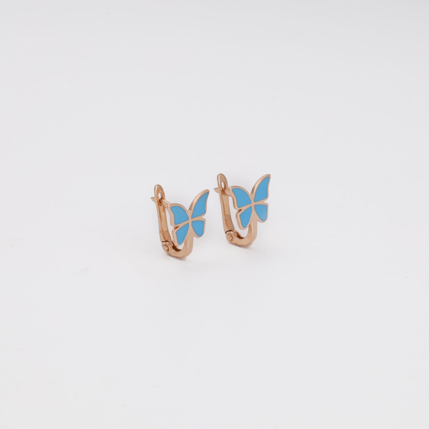 Rose gold butterfly earrings with blue enamel close-up view