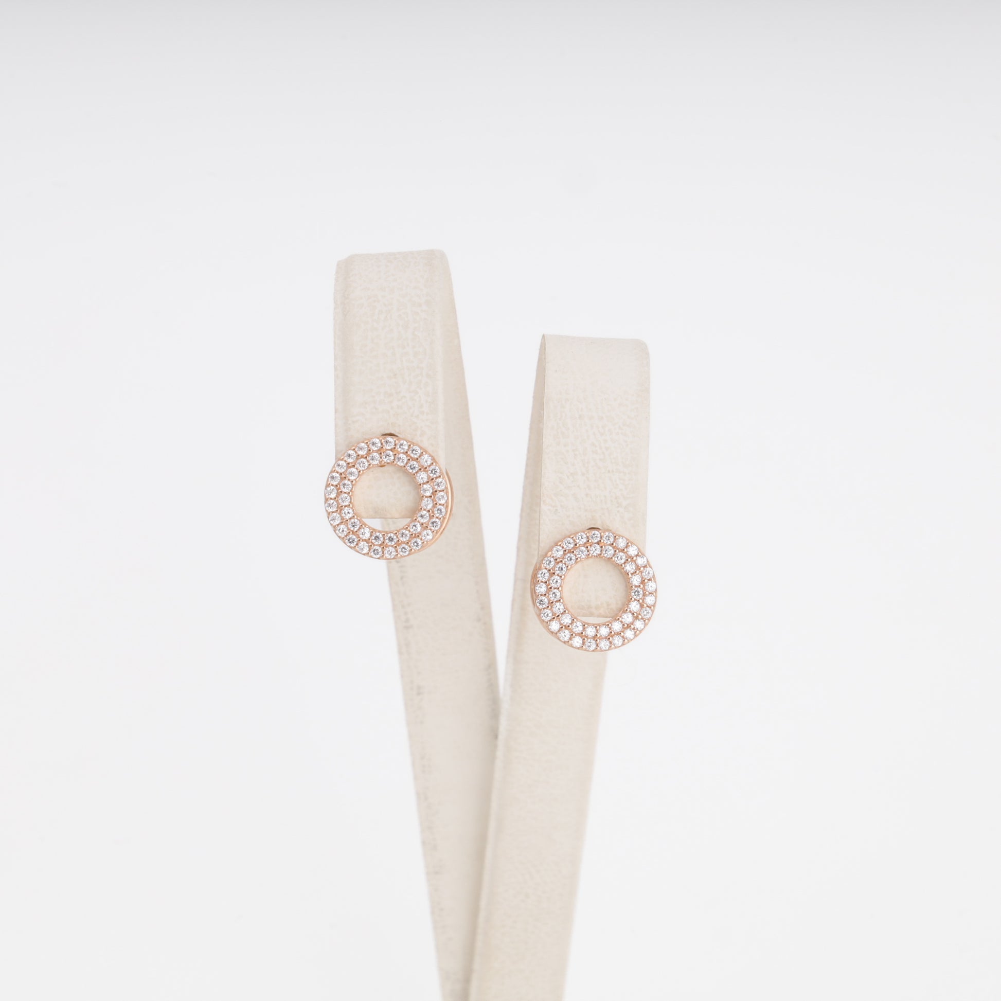 Circular pavé zirconia earrings in 14K rose gold on display stand — Kabluchka Jewelry Store