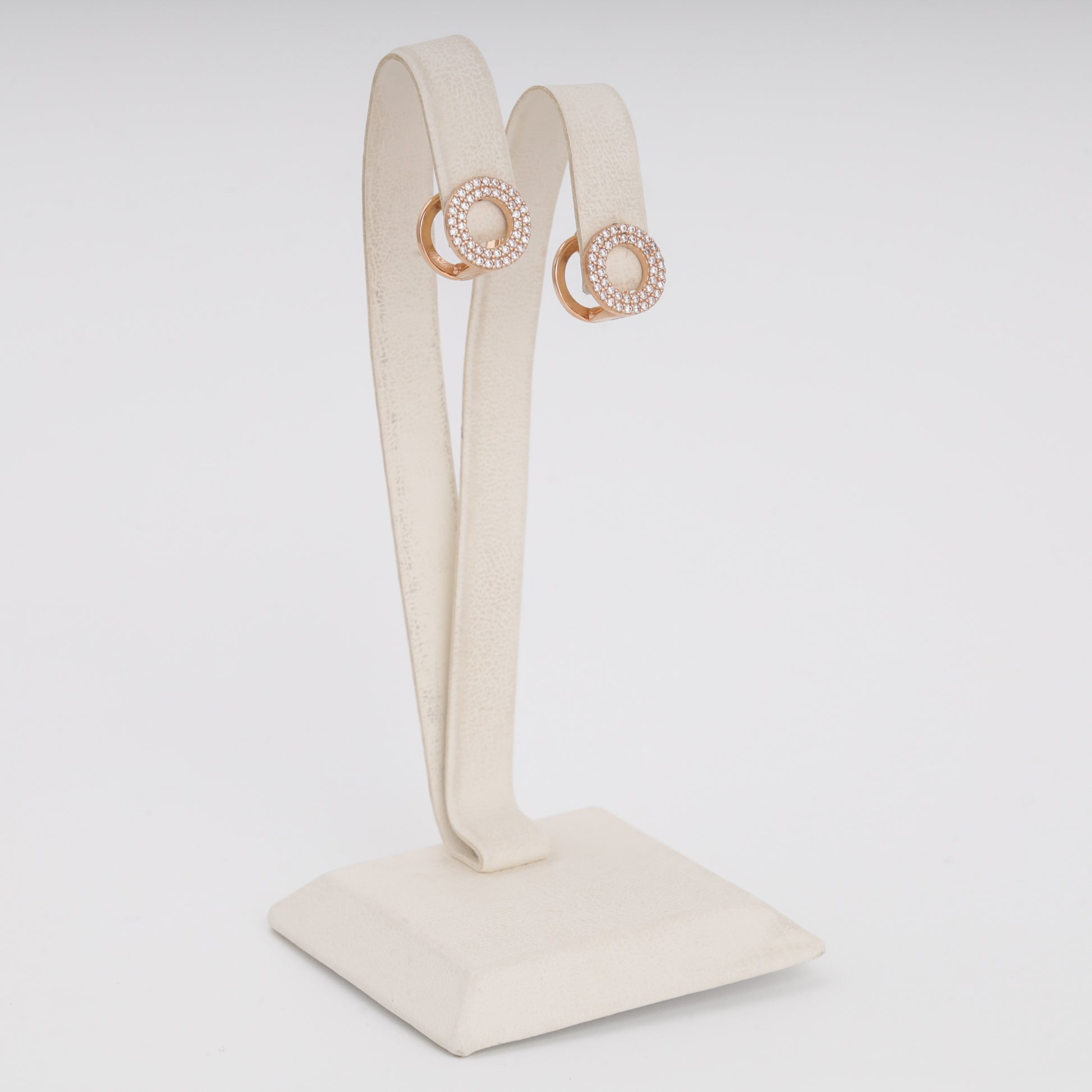 Rose gold circular CZ earrings close-up showing pavé stone setting