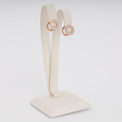 Rose gold circular CZ earrings close-up showing pavé stone setting