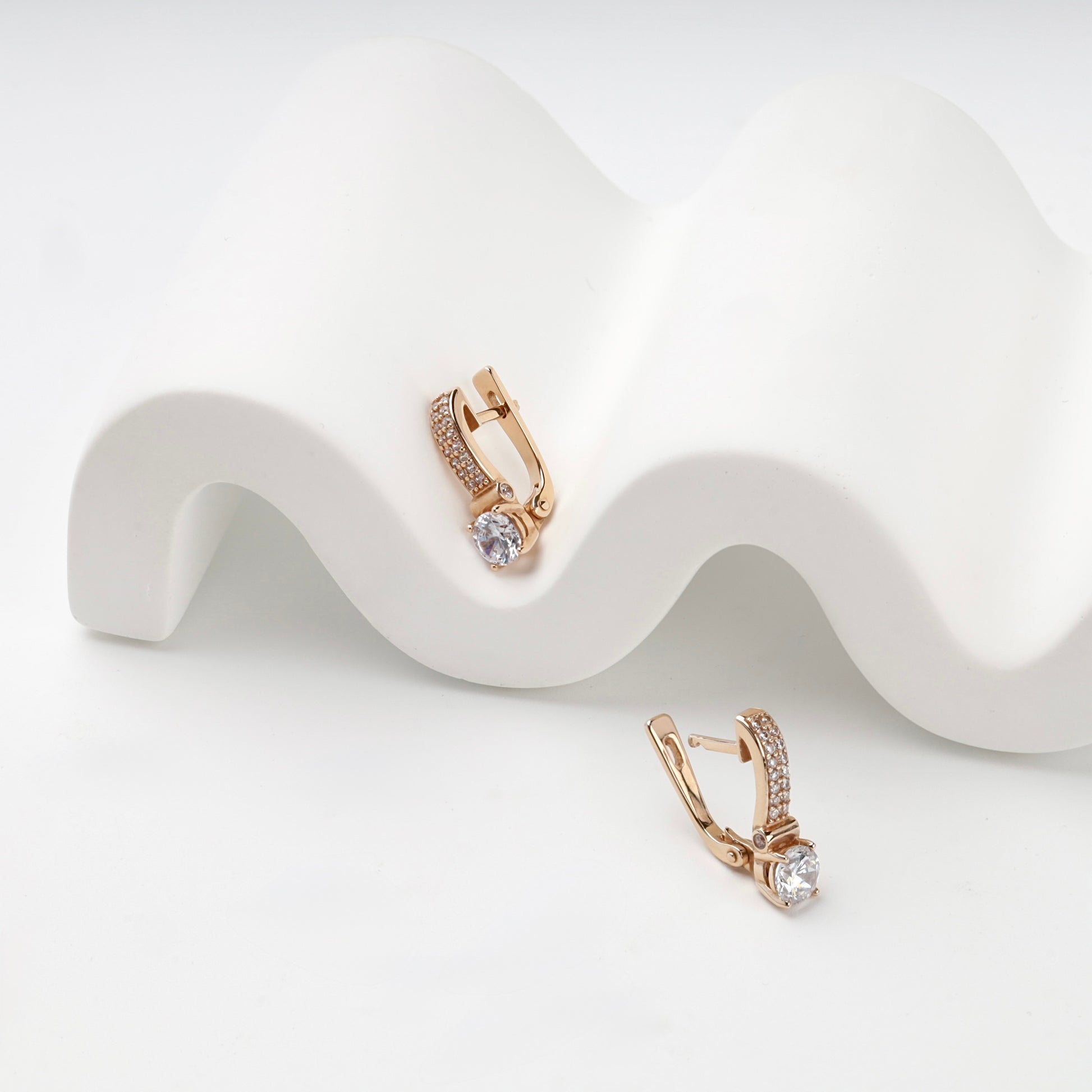 Rose gold cubic zirconia drop earrings, angled view — Kabluchka