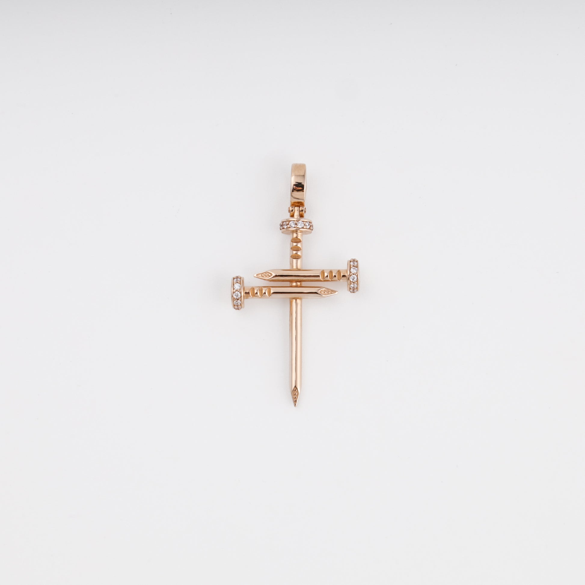 14K rose gold cross pendant made of three interlocking nails