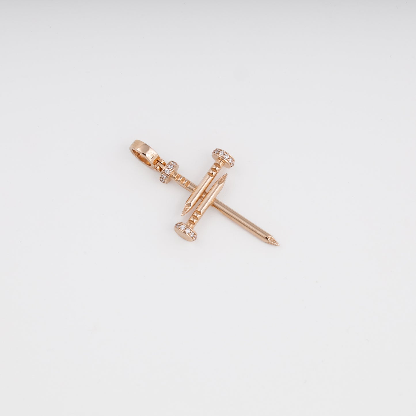 Nail cross pendant side angle showing rose gold craftsmanship