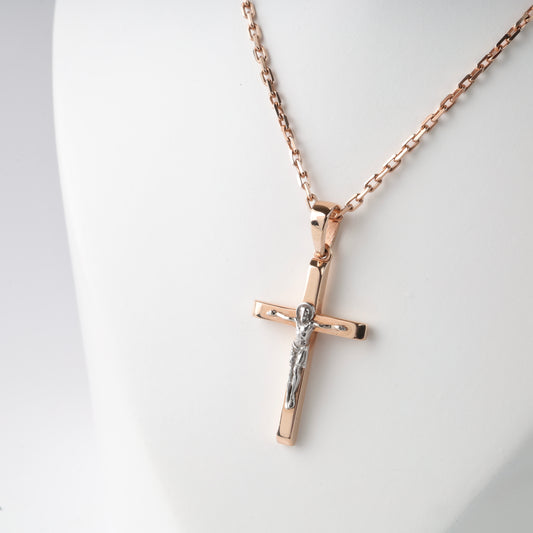 Rose gold cross pendant necklace on a white background