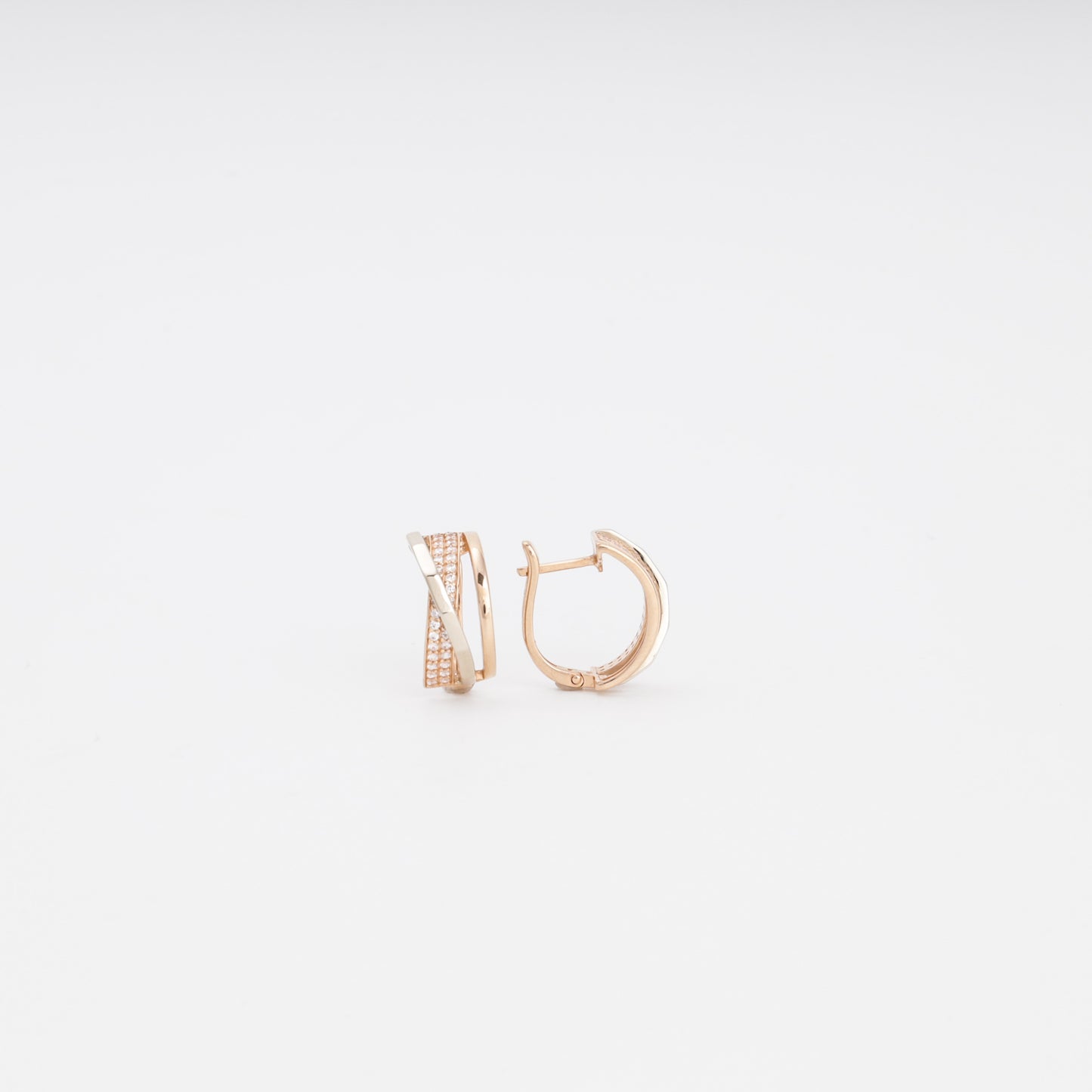 Gold 585 Crossover Huggie Earrings on Surface — Kabluchka