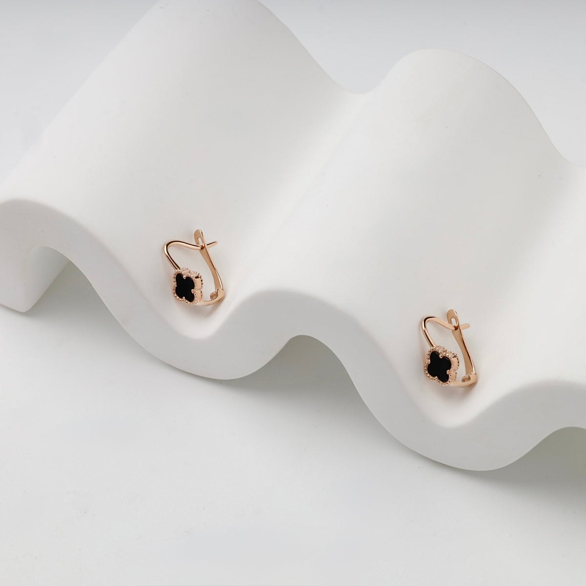 Rose gold 585 black onyx clover earrings, angled pair view