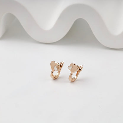 Rose Gold double heart kids earrings with white enamel, angled pair